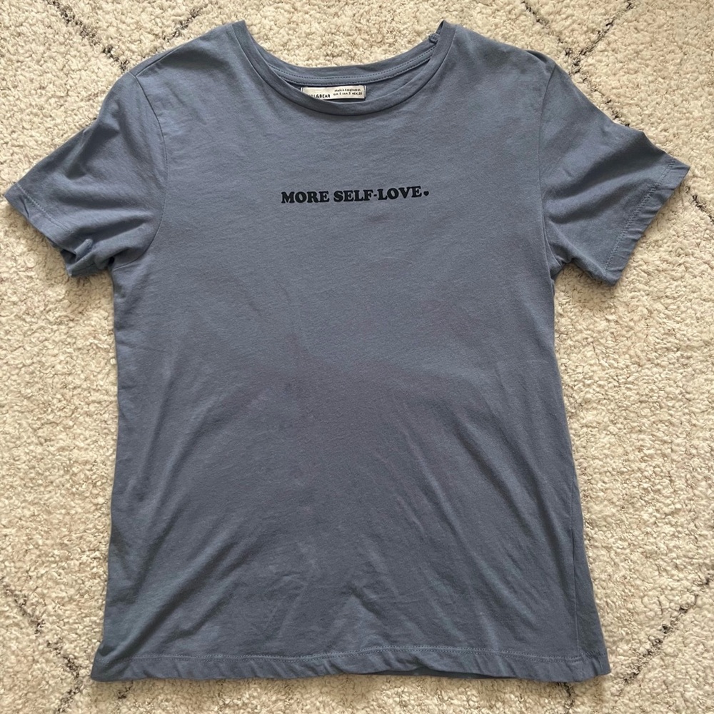 Graphic blue shirt. “love yourself”